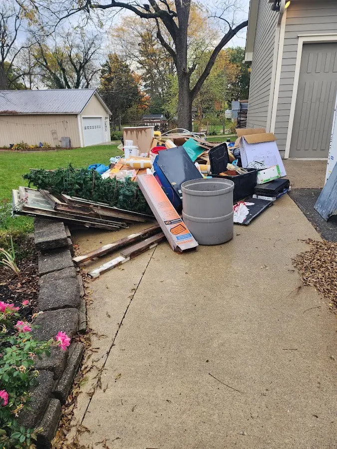 Dumpster being loaded with debris for Estate Cleanout Dumpster Rental in Hayfield